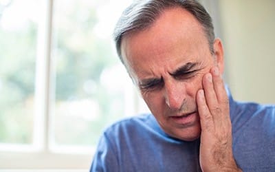 An older man with dental pain.