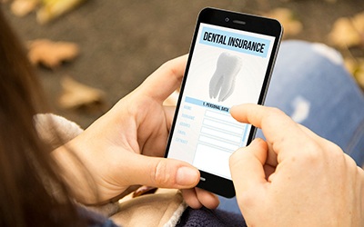 Looking at a dental insurance form on a smartphone