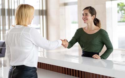 Employee explaining cost of dental emergencies in Wayland