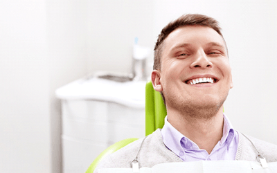 Man smiling while visiting emergency dentist in Wayland