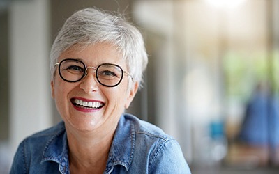 Senior woman with glasses smiling