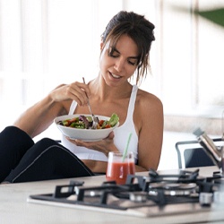 Woman eating a salad at home