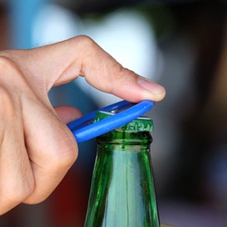 Man using bottle opener to open beverage