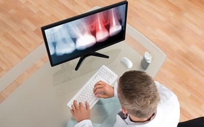 Dentist examining an X-ray.