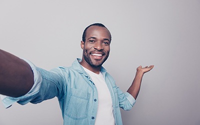 man taking a selfie and showing veneers in Wayland (for what are veneers section)