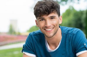 A teenager smiling.