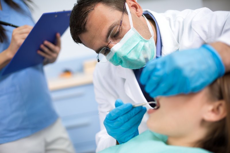 A dentist performing an exam in surgically clean air.