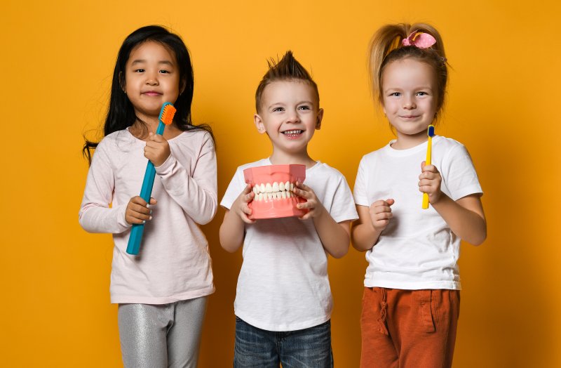 Dentist holding objects provided by a children’s dentist