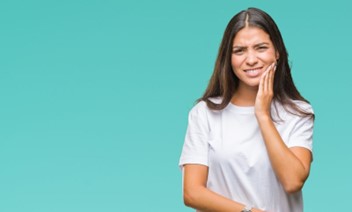 Woman with tooth pain touching her face